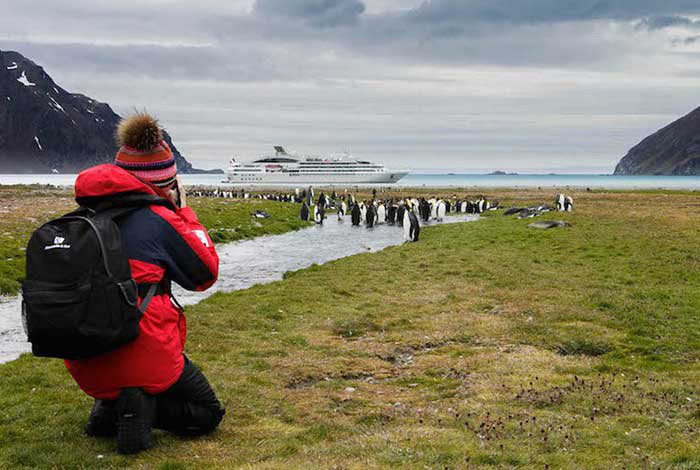 28 Dec Day 6 Guest Photographing Penguins And Ship At Fortuna Bay